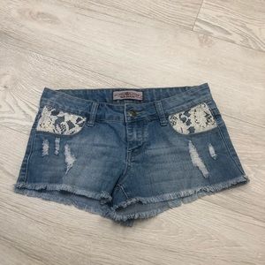 Blue denim short shorts with lace and rips